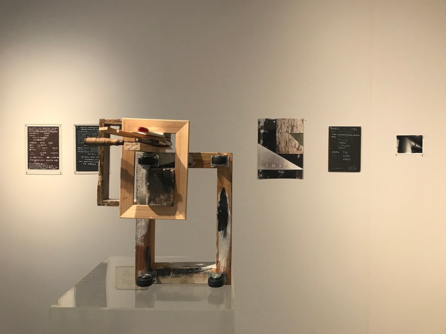 Mixed media sculpture by Richard Langley in front of works on paper by Gabrielle Rish